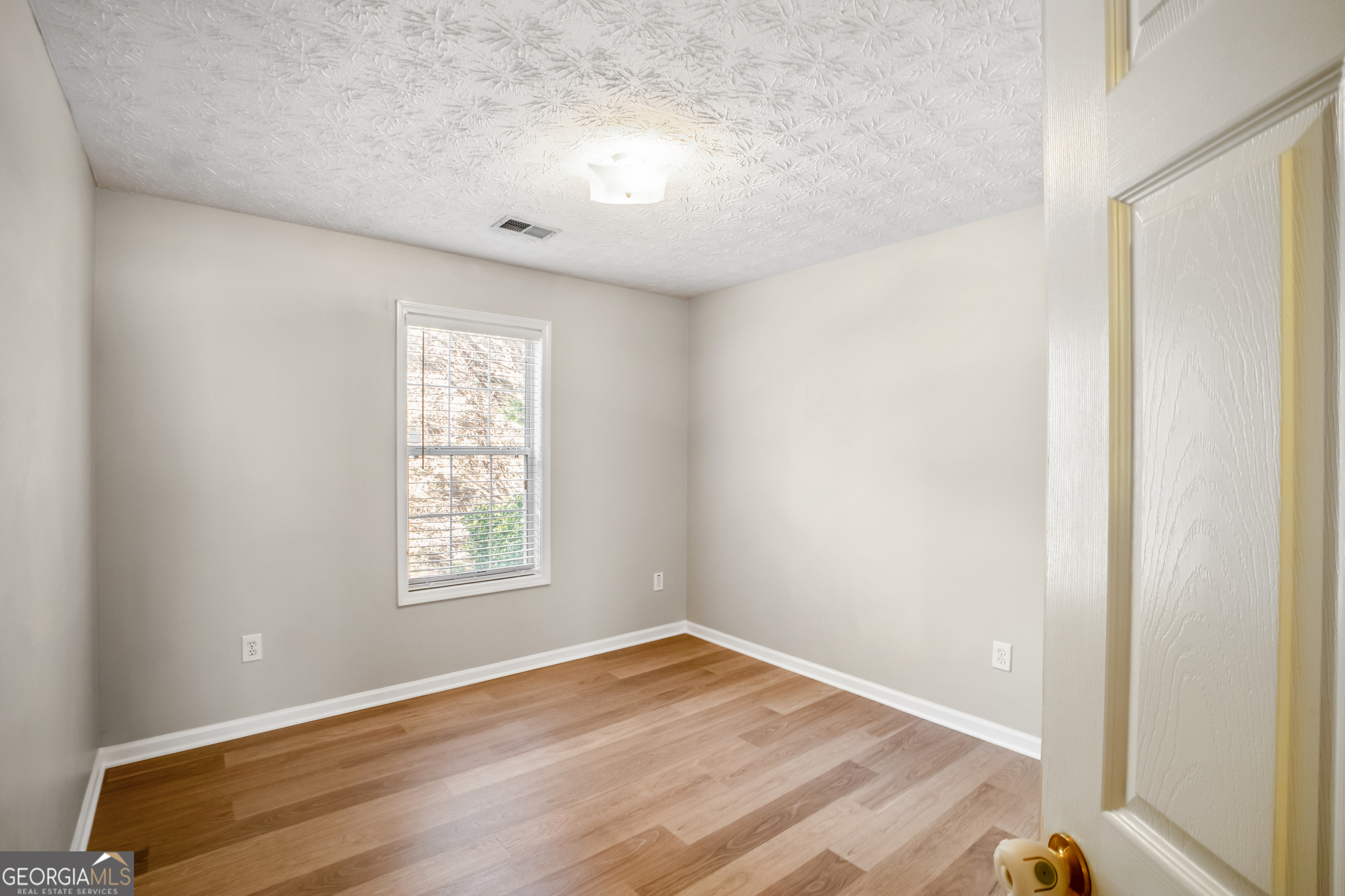 953 Azalea Court Winder, GA 30680 - Photo 18 of 56 an empty room with wooden floor and windows