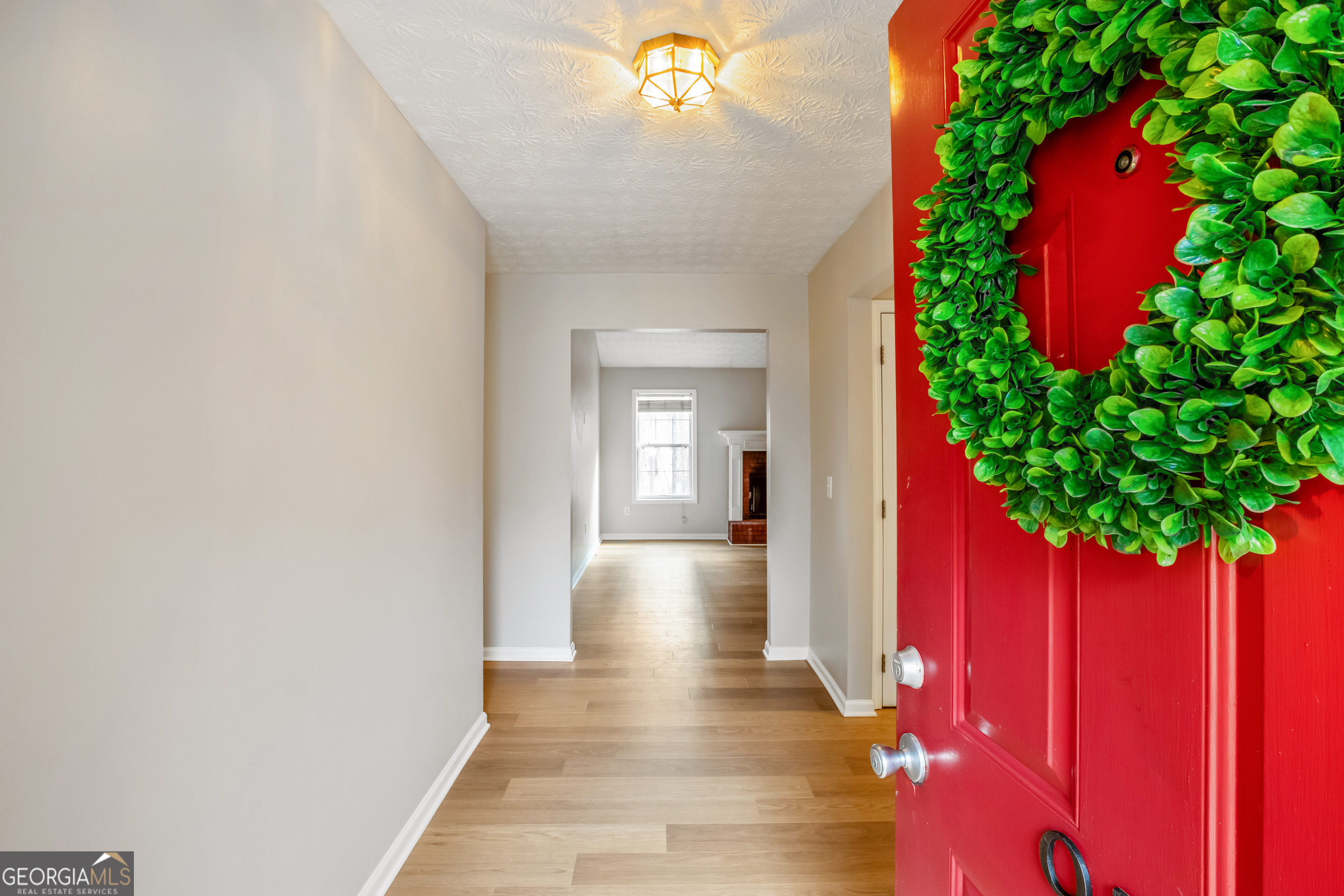 953 Azalea Court Winder, GA 30680 - Photo 2 of 56 a view of a hallway with wooden floor and a potted plant