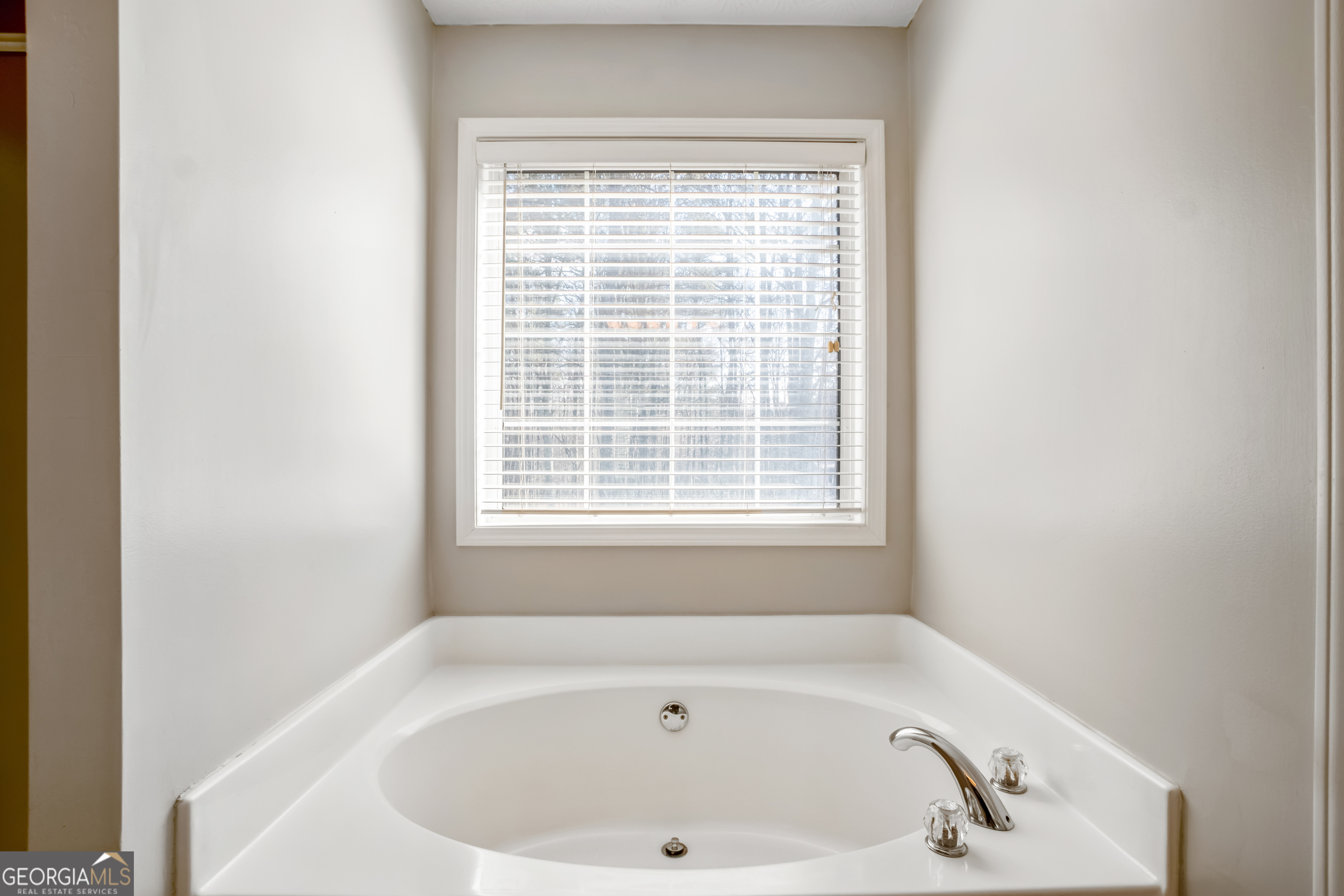 953 Azalea Court Winder, GA 30680 - Photo 26 of 56 a white bath tub sitting in a bathroom next to a window