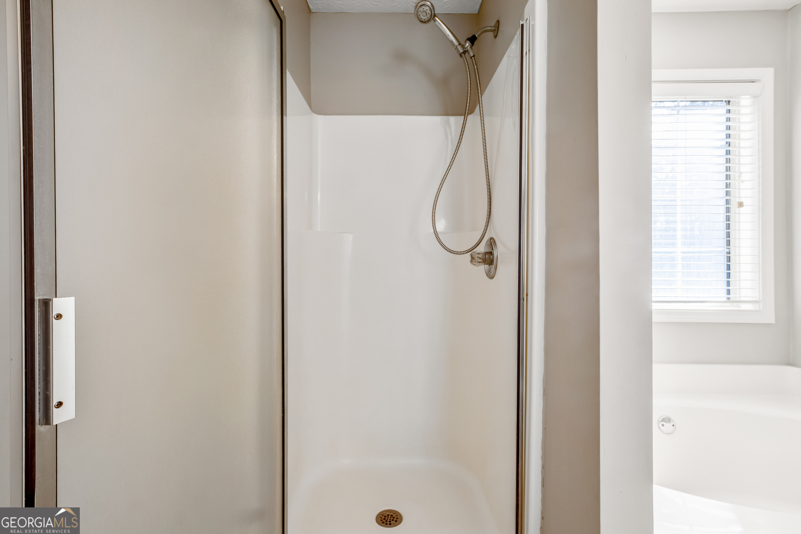 953 Azalea Court Winder, GA 30680 - Photo 27 of 56 a bathroom with a glass shower door