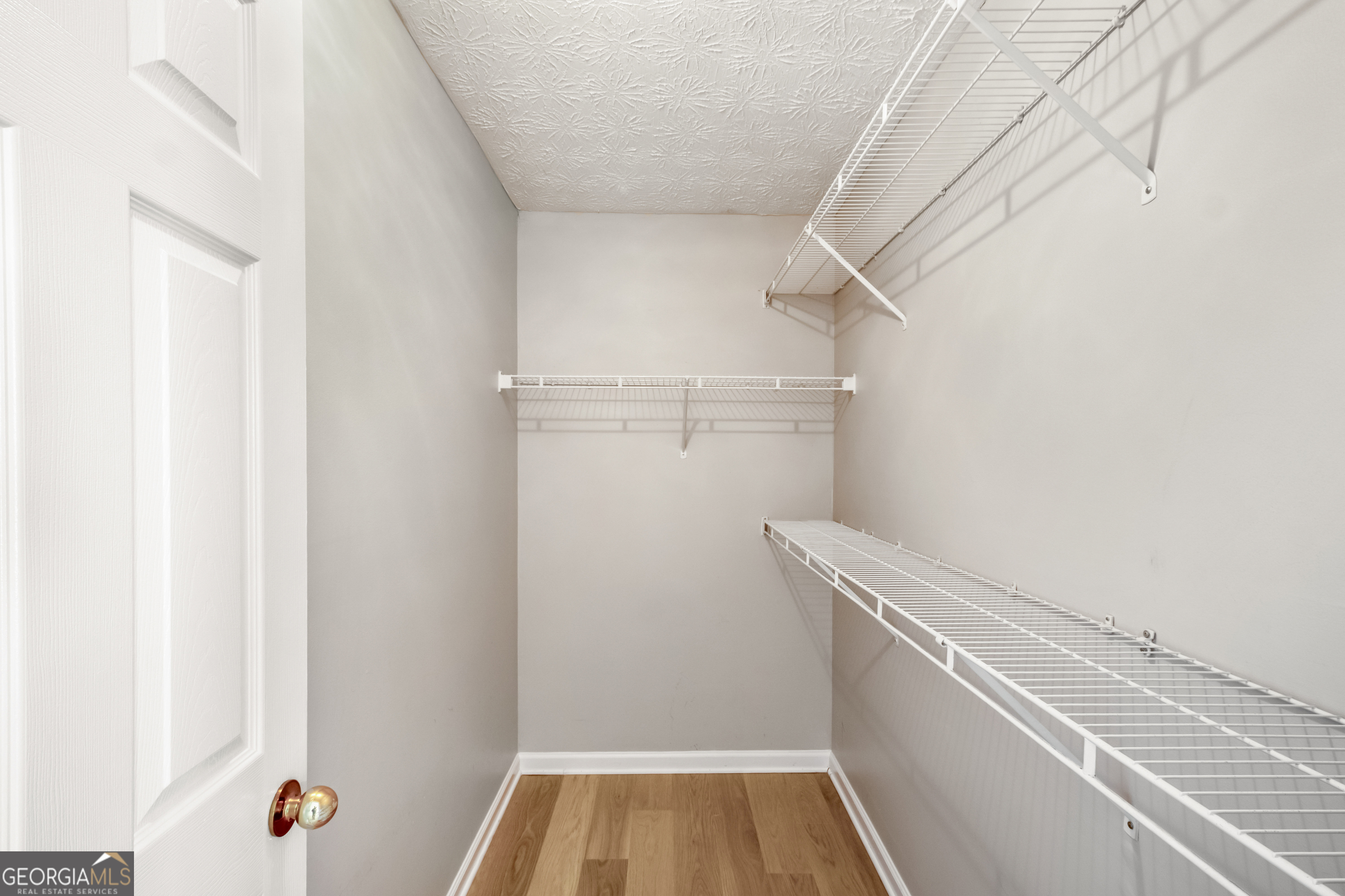 953 Azalea Court Winder, GA 30680 - Photo 28 of 56 a view of walk in closet with empty racks