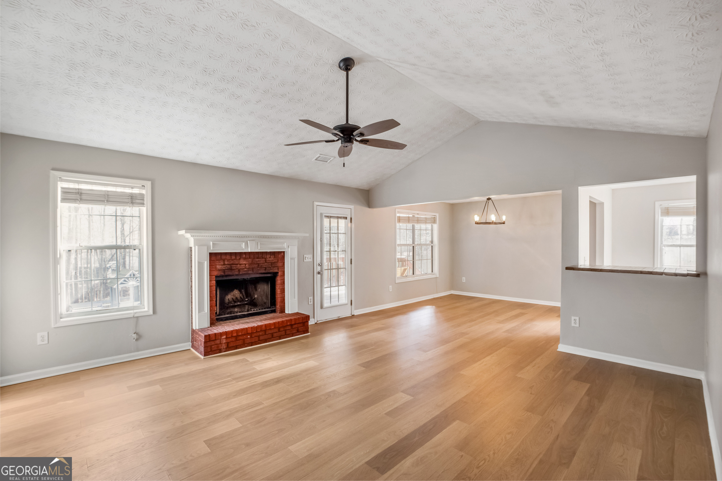 953 Azalea Court Winder, GA 30680 - Photo 3 of 56 a view of a livingroom with a fireplace a ceiling fan and windows