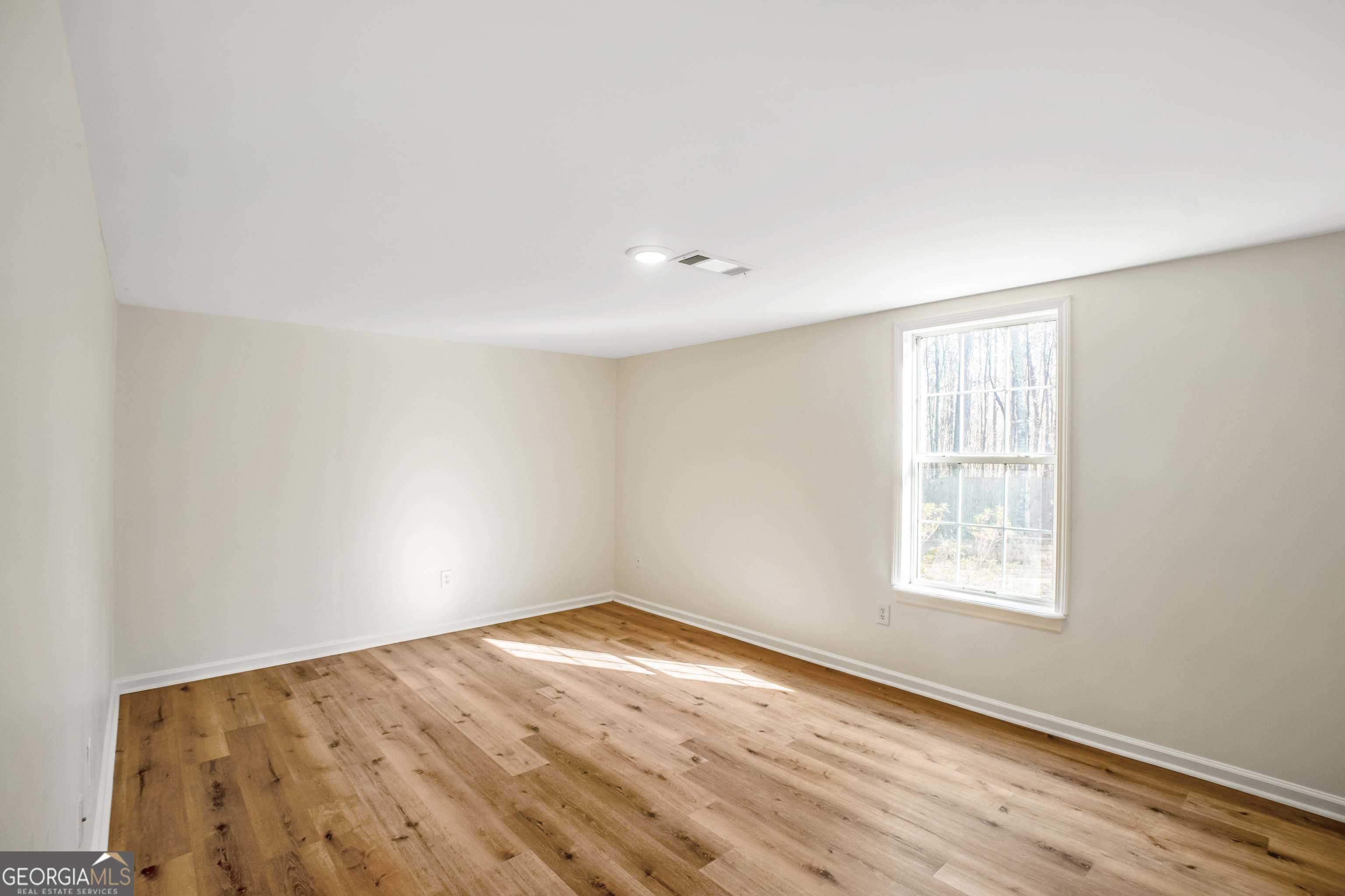 953 Azalea Court Winder, GA 30680 - Photo 33 of 56 an empty room with wooden floor and windows
