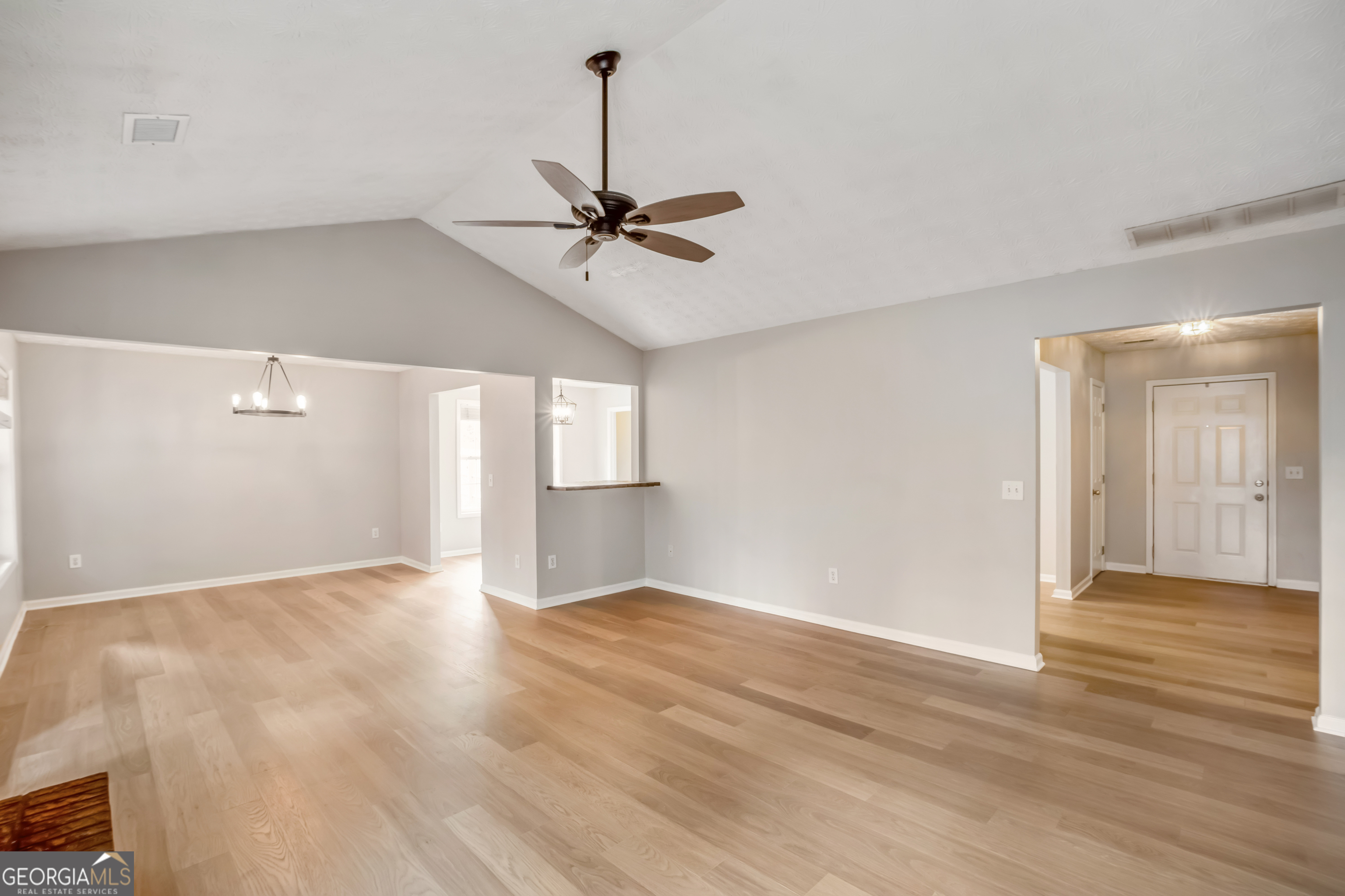 953 Azalea Court Winder, GA 30680 - Photo 4 of 56 a view of an empty room with window and wooden floor
