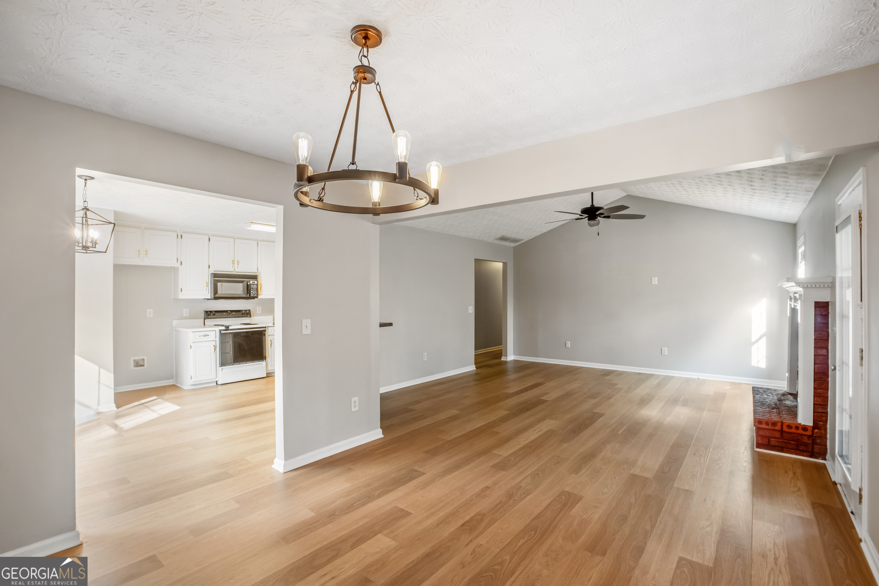 953 Azalea Court Winder, GA 30680 - Photo 8 of 56 a view of a room with wooden floor kitchen view and a chandelier