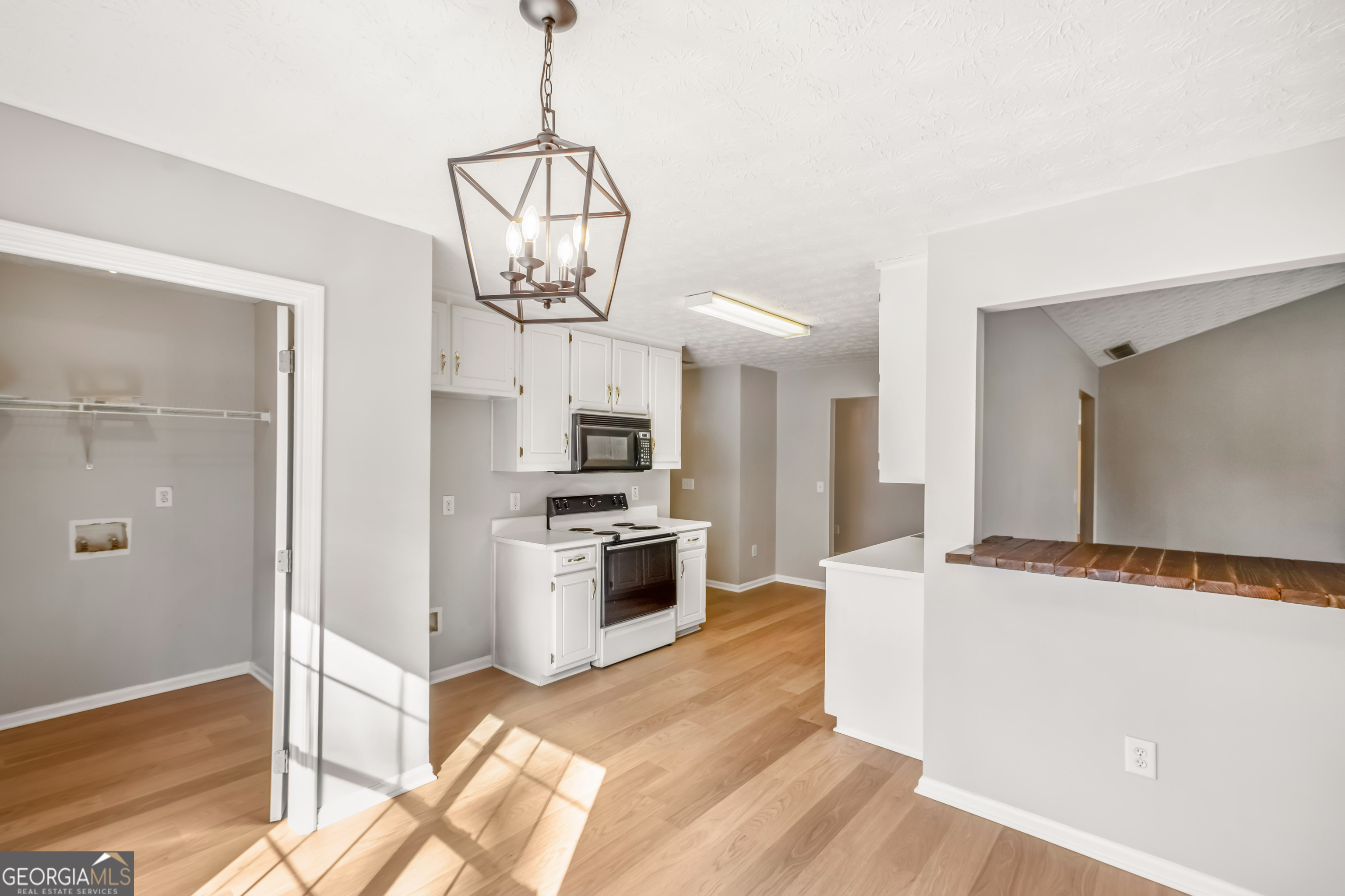 953 Azalea Court Winder, GA 30680 - Photo 9 of 56 a kitchen with stainless steel appliances granite countertop a refrigerator a stove oven a sink dishwasher and white cabinets with wooden floor