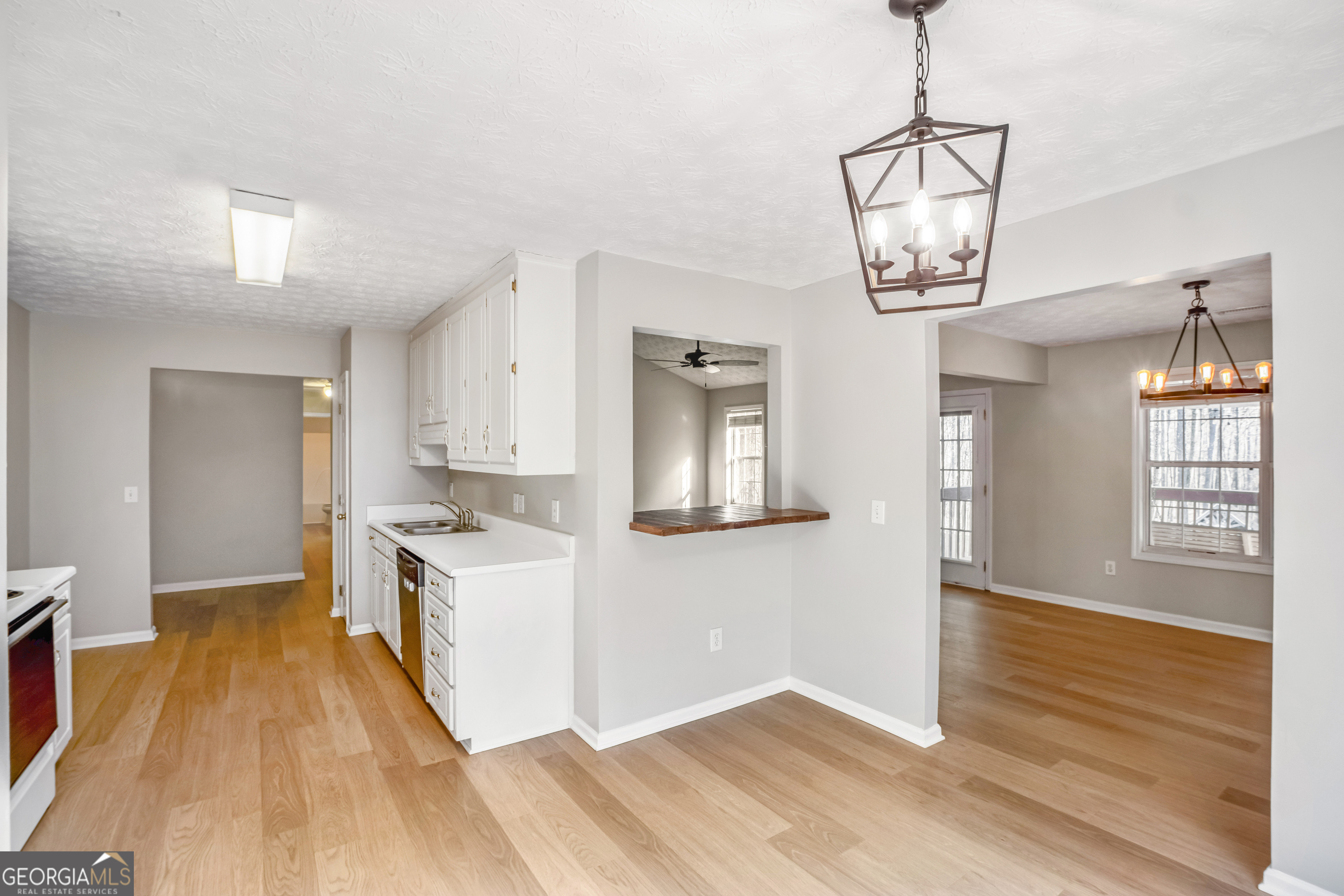 953 Azalea Court Winder, GA 30680 - Photo 10 of 56 a view of a room with wooden floor cabinet and a chandelier