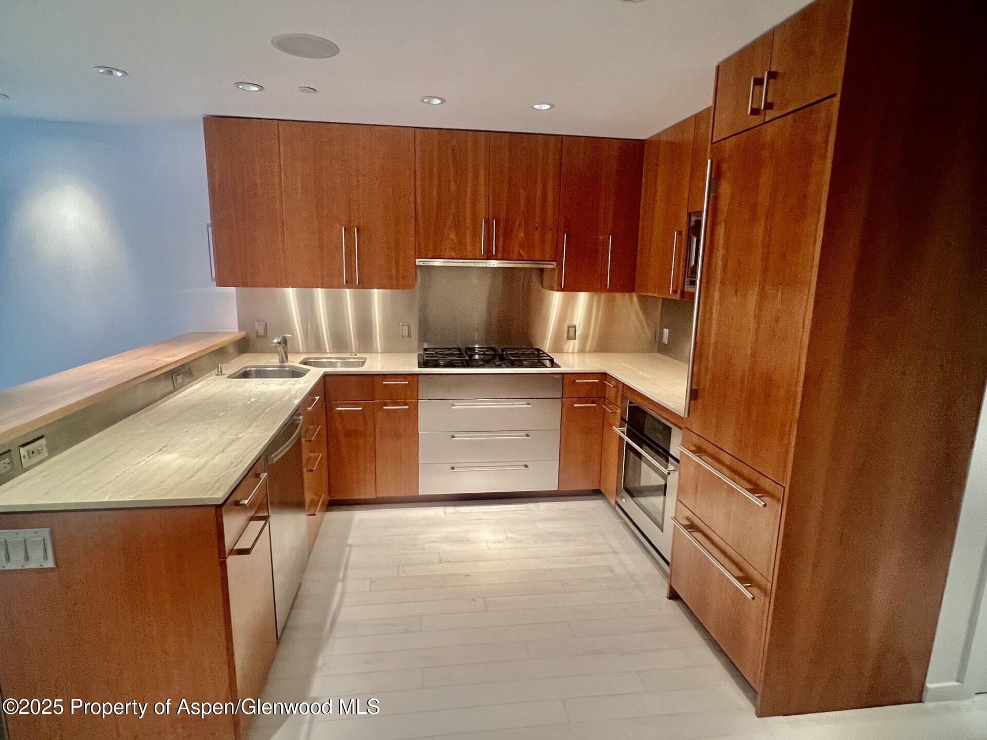 a kitchen with a sink a stove and a refrigerator