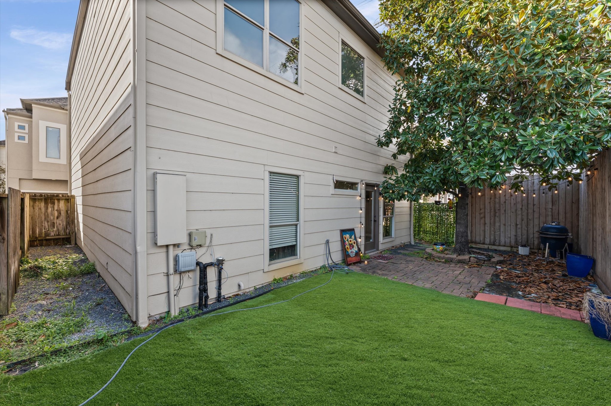 1166 Bonner Street Houston, TX 77007 - Photo 23 of 33 a view of a backyard with table and chairs and a large tree