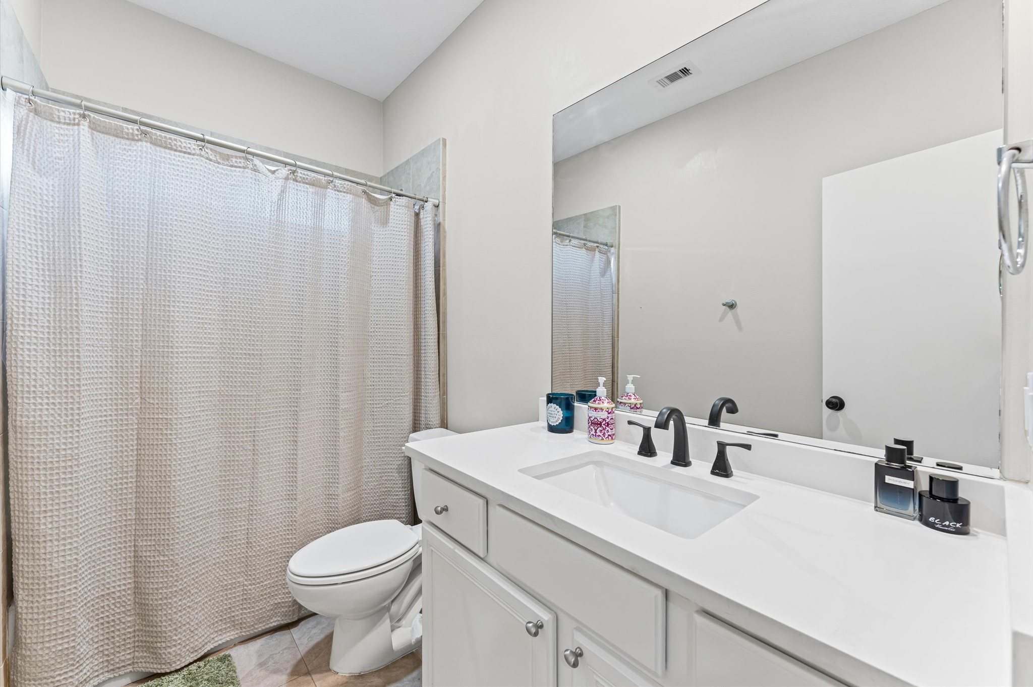 1166 Bonner Street Houston, TX 77007 - Photo 9 of 33 a bathroom with a sink a toilet and shower curtain