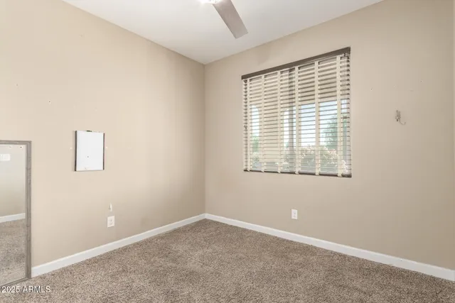 an empty room with closet and a bathroom