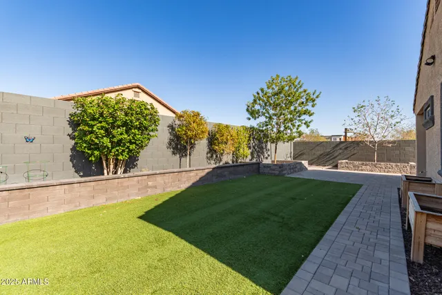a backyard of a house with table and chairs