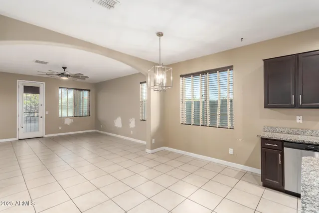 a large kitchen with kitchen island a large counter space a sink appliances and cabinets
