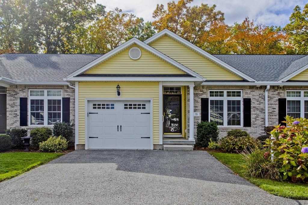 a front view of a house with a garden and plants