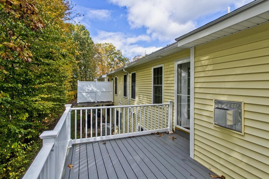 73 Beech Hill Road, Unit 73 West Springfield, MA 01089 - Photo 12 of 29 a view of deck with wooden floor and fence with a garden