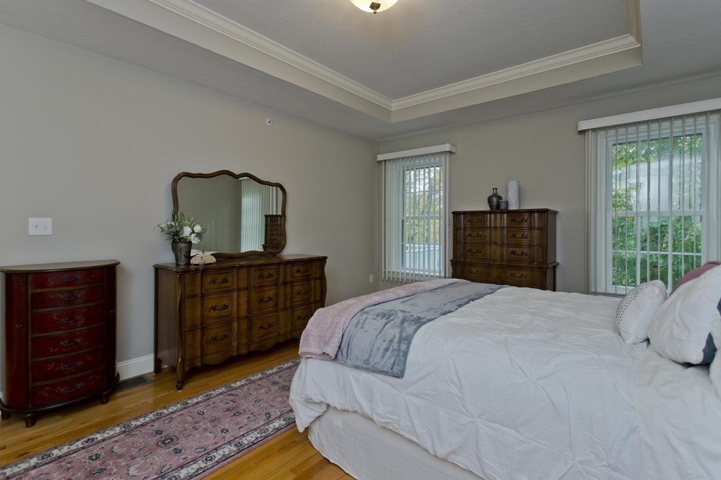 73 Beech Hill Road, Unit 73 West Springfield, MA 01089 - Photo 17 of 29 a bedroom with a bed and wooden floor