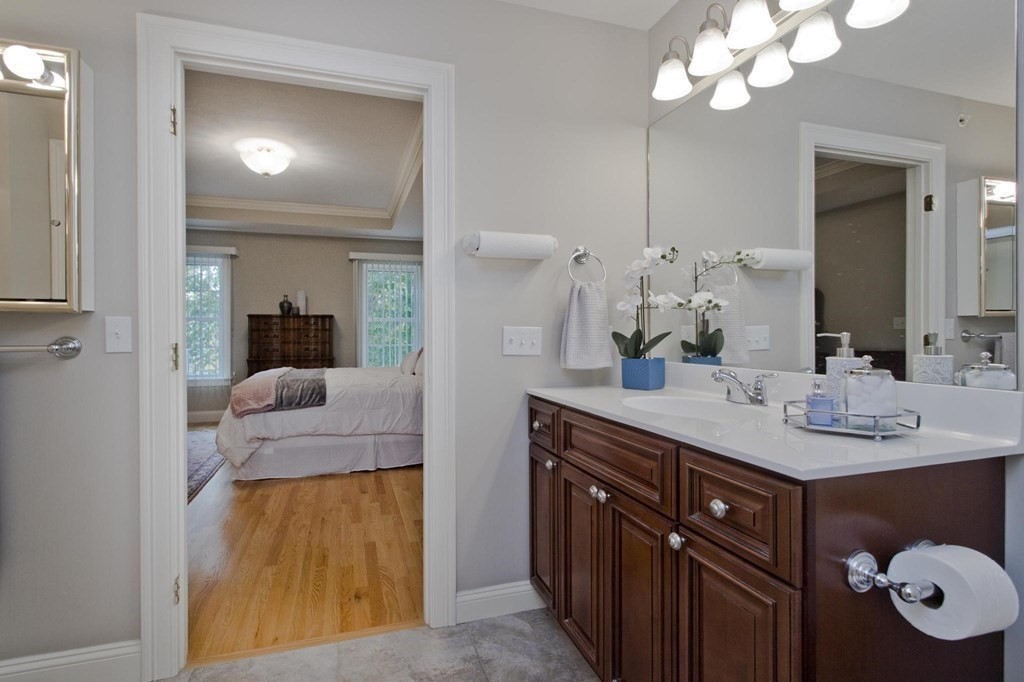 73 Beech Hill Road, Unit 73 West Springfield, MA 01089 - Photo 19 of 29 a bathroom with a granite countertop sink and a mirror