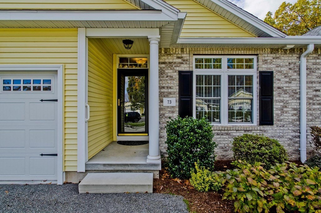 73 Beech Hill Road, Unit 73 West Springfield, MA 01089 - Photo 2 of 29 a front view of a house with a garden