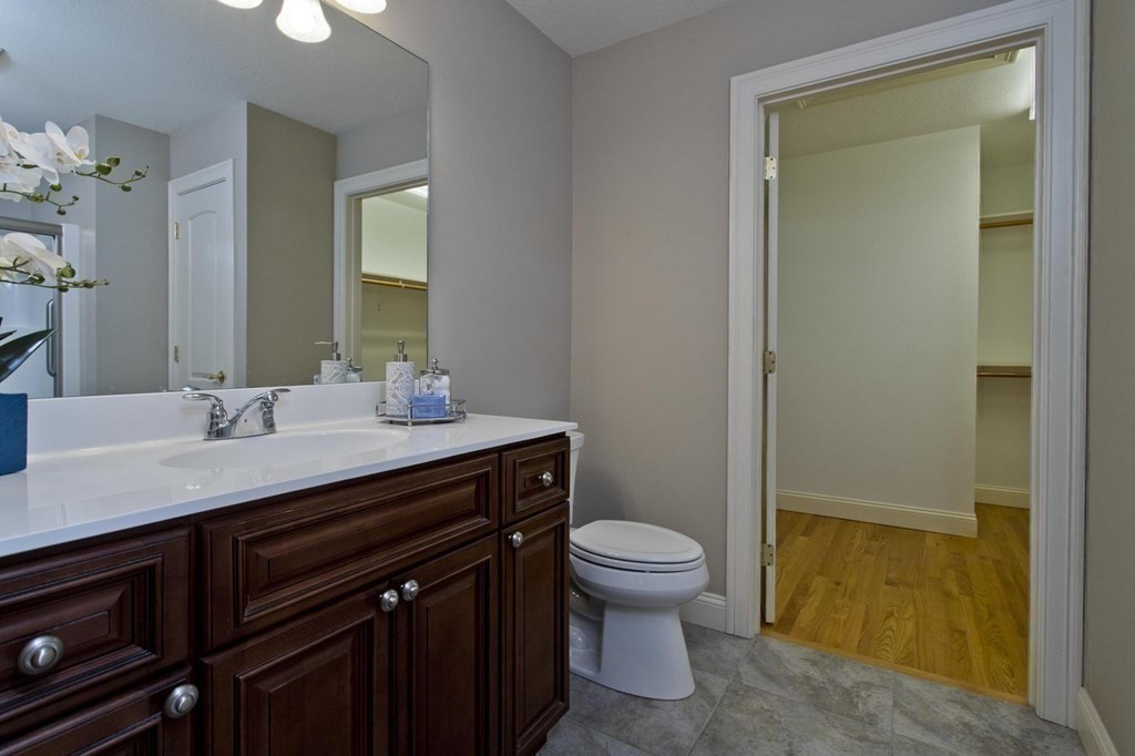 73 Beech Hill Road, Unit 73 West Springfield, MA 01089 - Photo 21 of 29 a bathroom with a sink a toilet a mirror and vanity