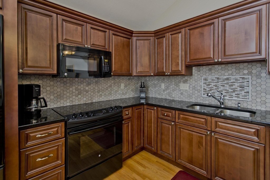 73 Beech Hill Road, Unit 73 West Springfield, MA 01089 - Photo 3 of 29 a kitchen with granite countertop cabinets stainless steel appliances and a sink