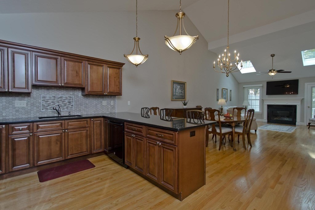 73 Beech Hill Road, Unit 73 West Springfield, MA 01089 - Photo 6 of 29 a kitchen with stainless steel appliances granite countertop wooden cabinets a dining table and chairs