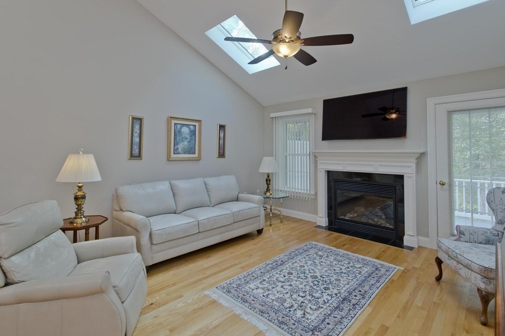 73 Beech Hill Road, Unit 73 West Springfield, MA 01089 - Photo 10 of 29 a living room with furniture a rug and a fireplace