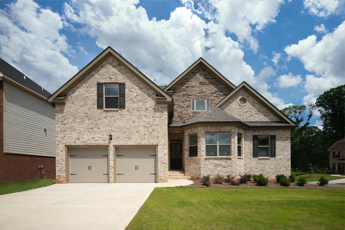 626 Edgar Street, Unit 21 Hampton, GA 30228 - Photo 1 of 1 a front view of a house with a yard