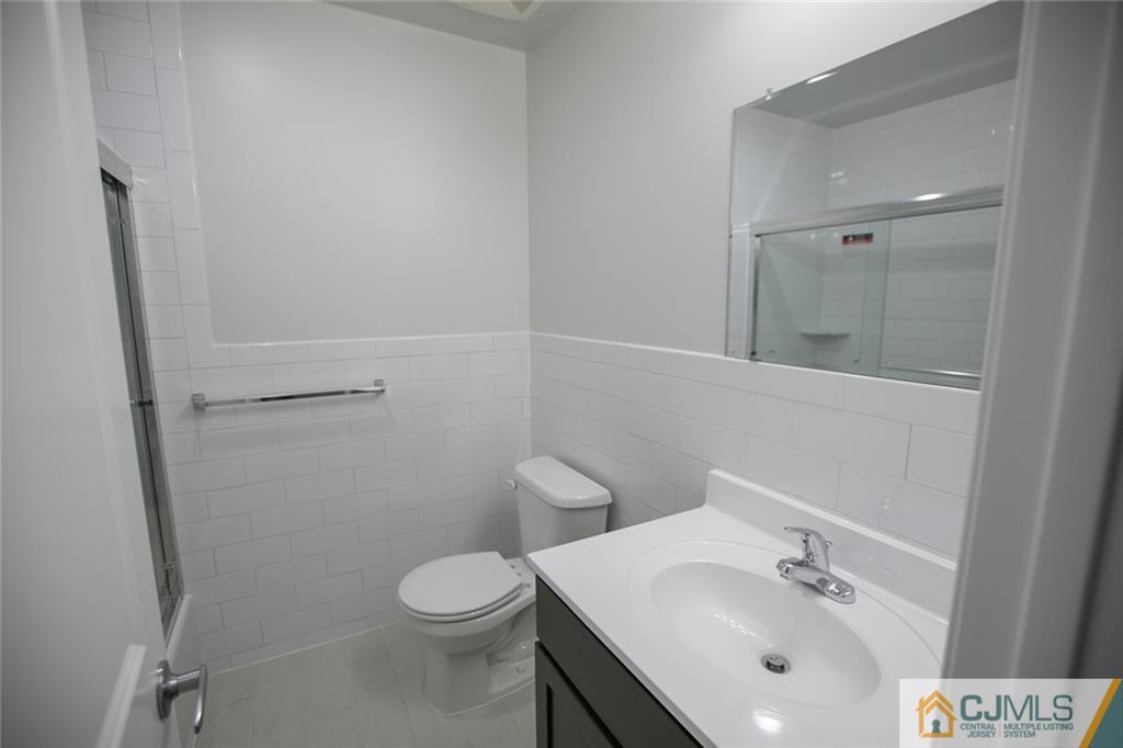 3405 Hana Road Edison, NJ 08817 - Photo 42 of 69 a bathroom with a sink a toilet and shower