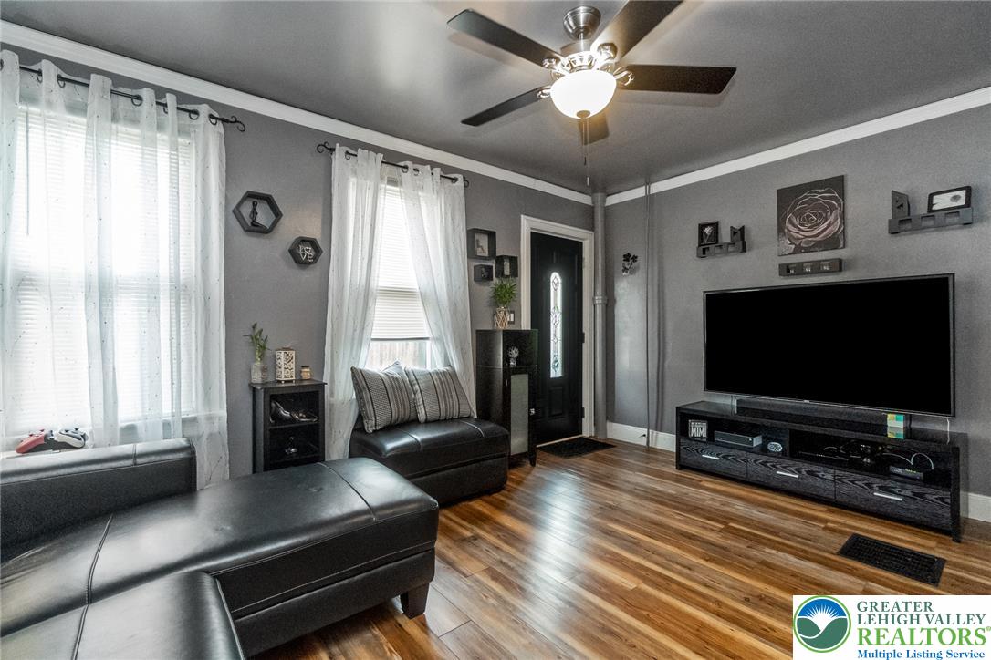 365 Rock Street Easton, PA 18042 - Photo 9 of 50 Lustrous hardwood-style flooring extends across this well-lit living space, featuring a classic ceiling fan.