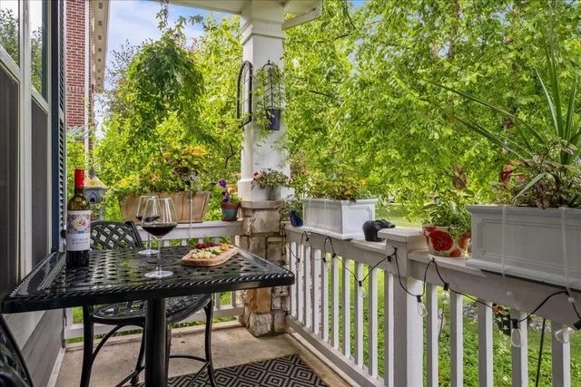 a view of a patio with table and chairs and potted plants