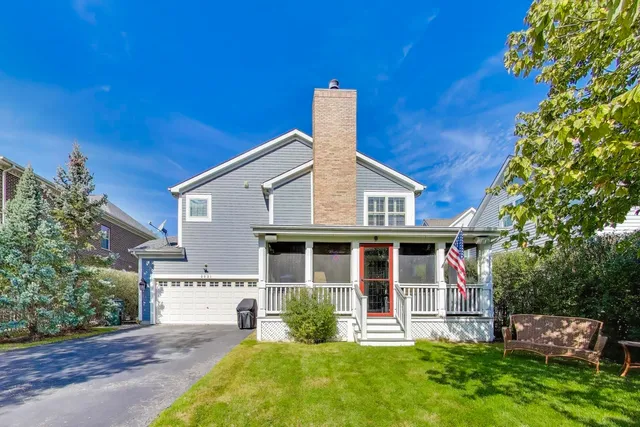 a front view of a house with a yard table and chairs