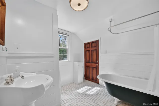 a bathroom with a bathtub and a sink