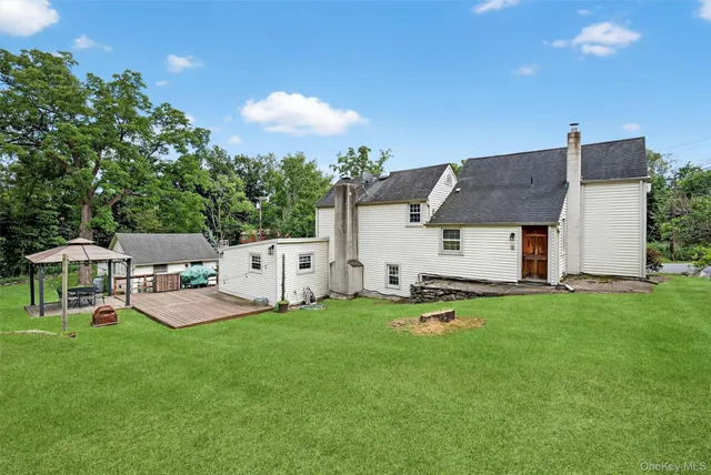 a backyard of a house with table and chairs