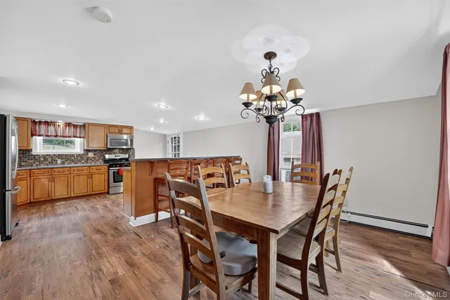 a view of a dining room with furniture and wooden floor