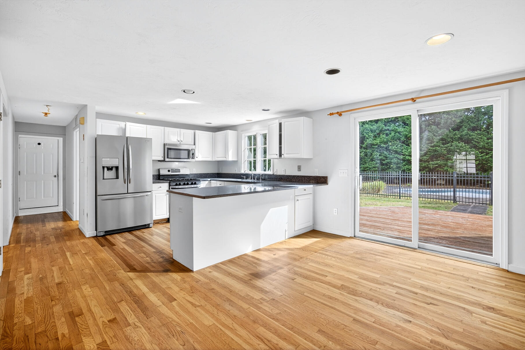 30 Fox Crossing Road Brewster, MA 02631 - Photo 12 of 36 a kitchen with granite countertop a refrigerator and wooden cabinets