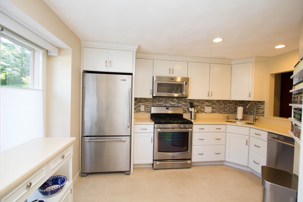 13 Deer Path, Unit 3 Maynard, MA 01754 - Photo 3 of 21 a kitchen with a refrigerator sink and wooden floor