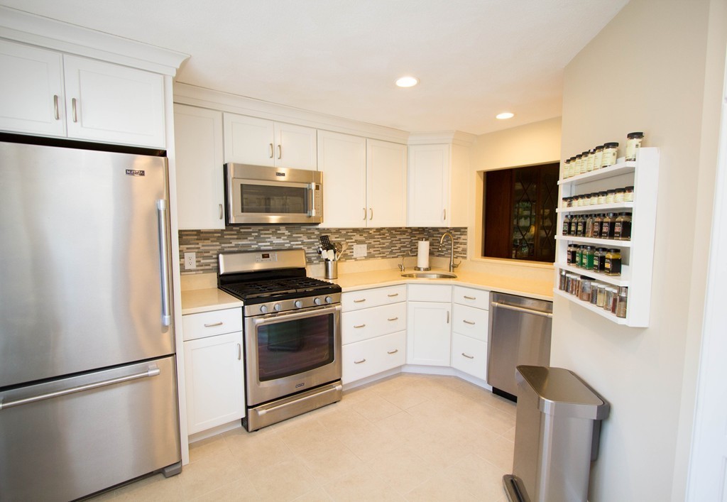 13 Deer Path, Unit 3 Maynard, MA 01754 - Photo 4 of 21 a kitchen with cabinets and stainless steel appliances