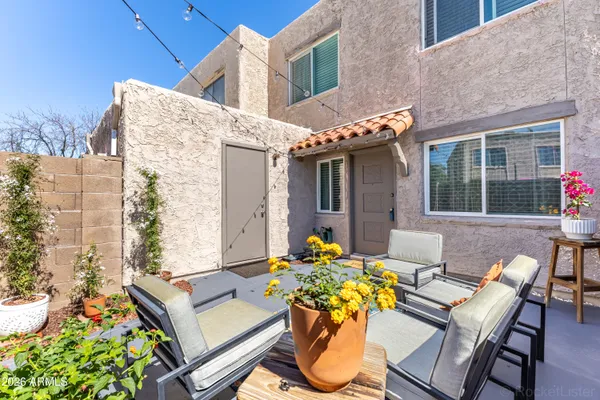 a view of a patio with table and chairs and potted plants