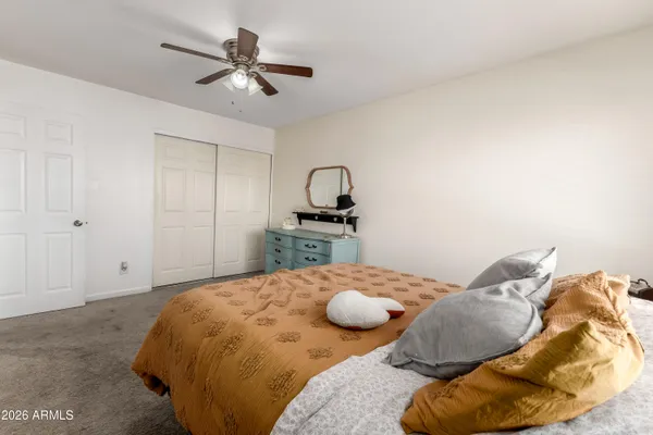 a bedroom with a bed and ceiling fan