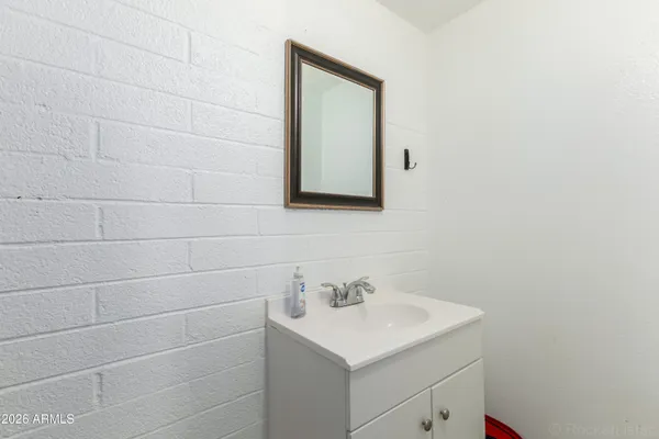 a bathroom with a sink and mirror