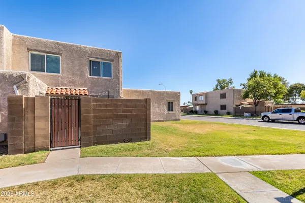a view of a house with backyard and sitting area