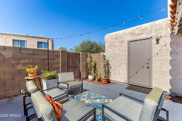 a view of a patio with table and chairs and potted plants