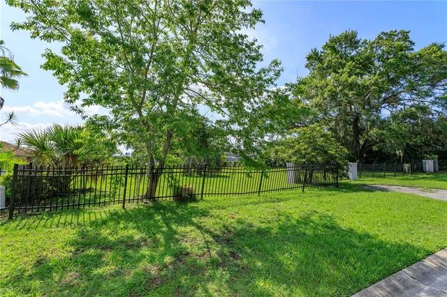 a view of a field of grass and trees