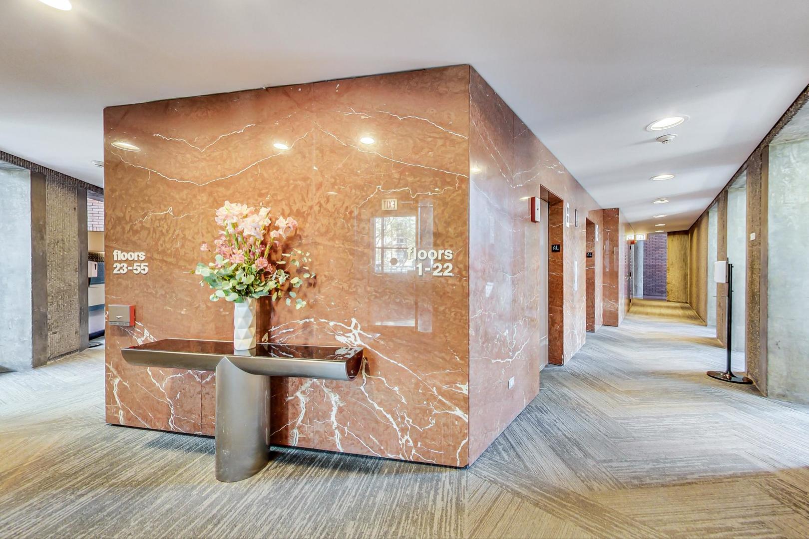 5415 North Sheridan Road, Unit 2904 Chicago, IL 60640 - Photo 16 of 49 a view of a hallway with wooden floor and a potted plant