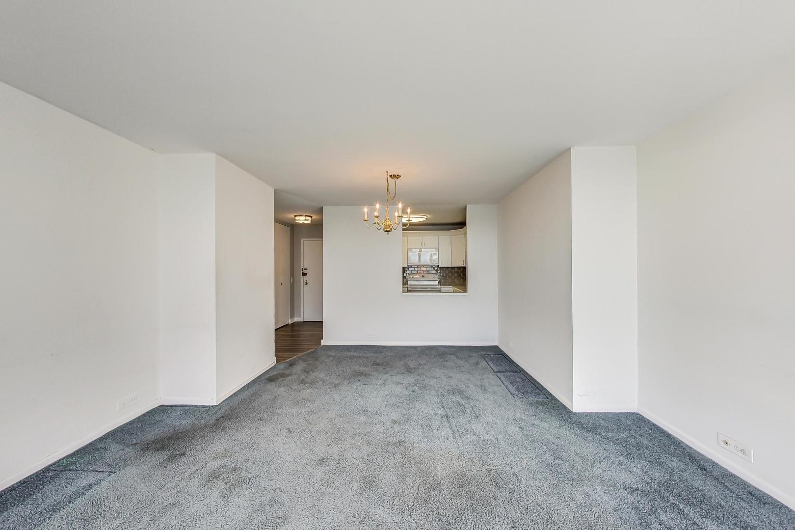 5415 North Sheridan Road, Unit 2904 Chicago, IL 60640 - Photo 22 of 49 an empty room with a kitchen and a sink