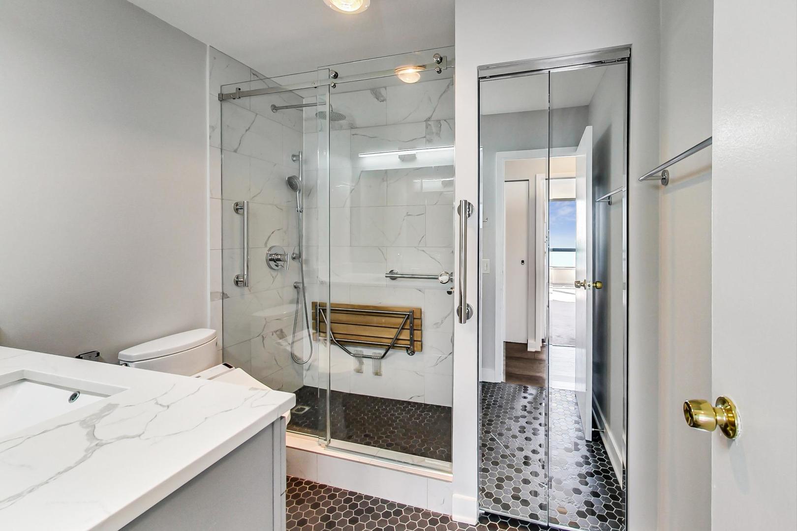 5415 North Sheridan Road, Unit 2904 Chicago, IL 60640 - Photo 35 of 49 a bathroom with a shower and a sink