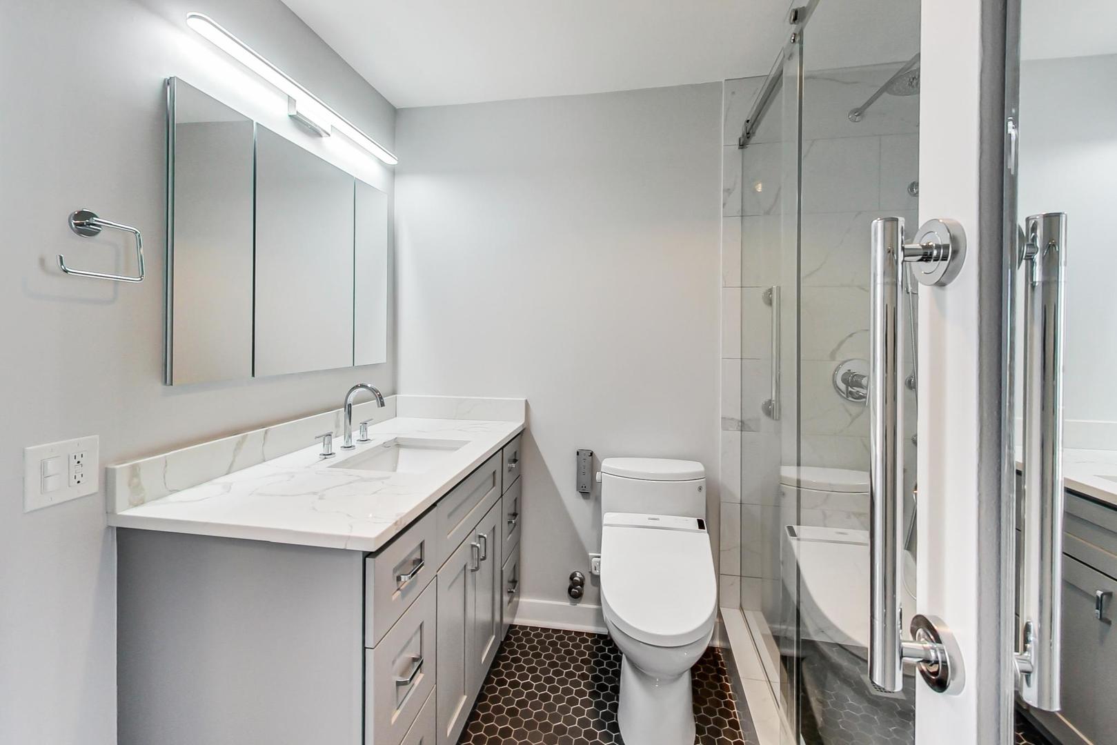 5415 North Sheridan Road, Unit 2904 Chicago, IL 60640 - Photo 36 of 49 a bathroom with a toilet a sink and mirror