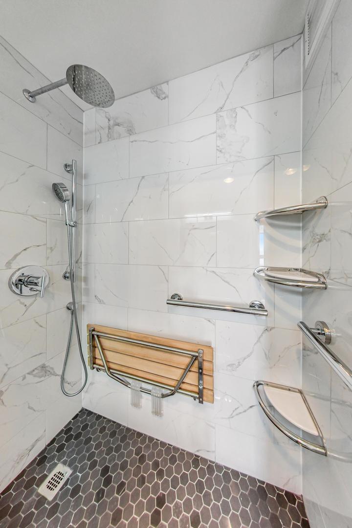 5415 North Sheridan Road, Unit 2904 Chicago, IL 60640 - Photo 37 of 49 a bathroom with a bathtub and a shower