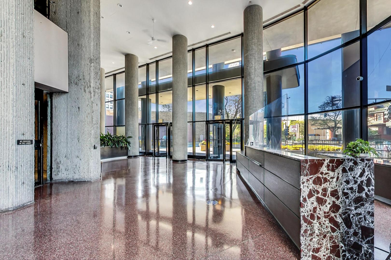 5415 North Sheridan Road, Unit 2904 Chicago, IL 60640 - Photo 9 of 49 a lobby with furniture and large windows