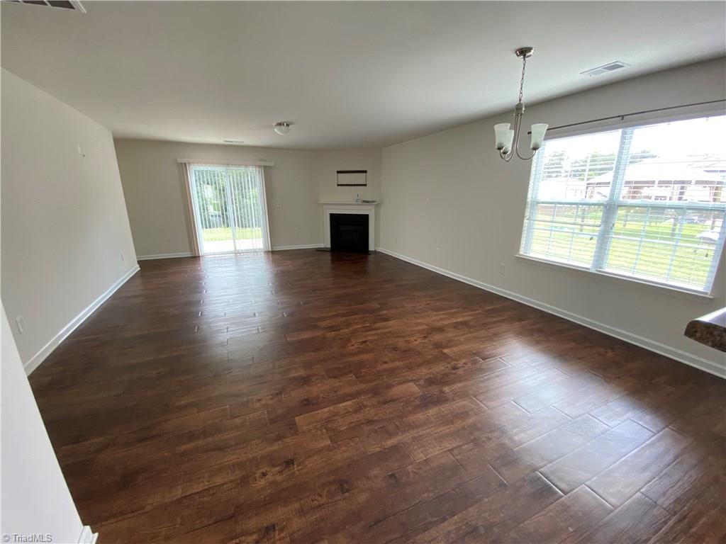 6468 Bentbrush Street Rural Hall, NC 27045 - Photo 4 of 23 Huge living/dining with wood floor, gas log fireplace, and lots of natural light.
